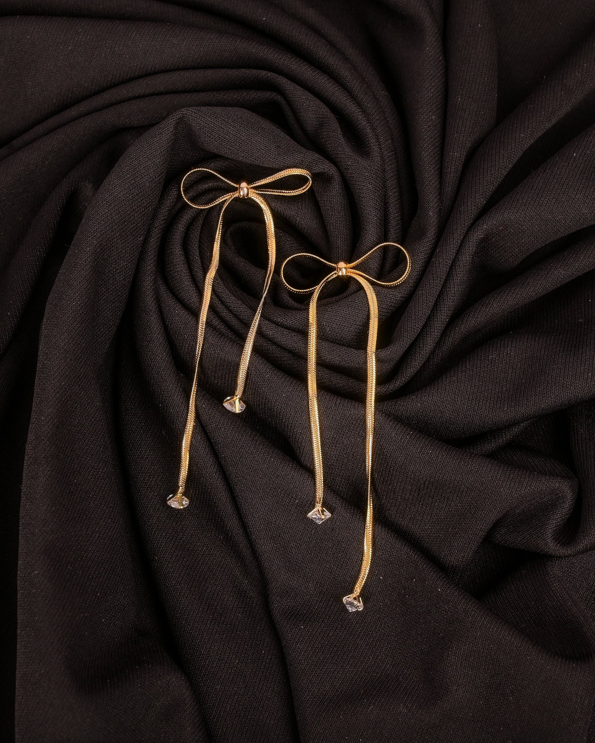 Dark fabric with gold drawstrings on a dark background