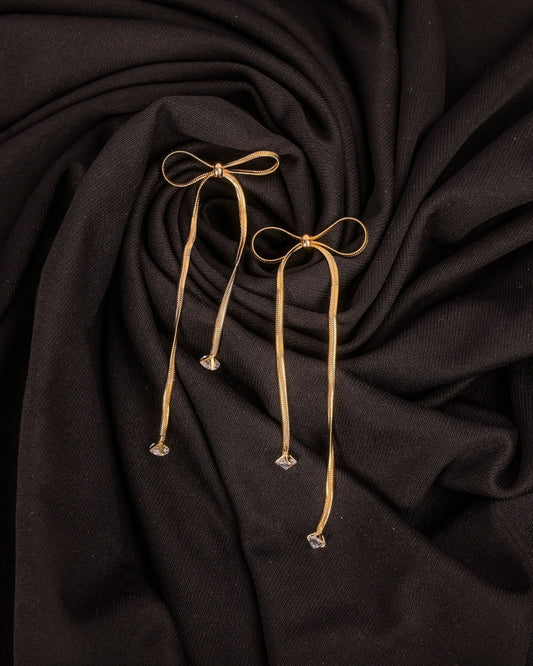 Dark fabric with gold drawstrings on a dark background